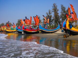 Vibrant colourful wooden fishing boat on the sore of Bay of bengal in cox's Bazar