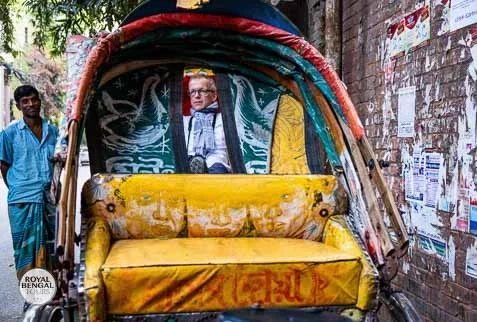 A foreigner is relaxed on the rickshaw in Dhaka