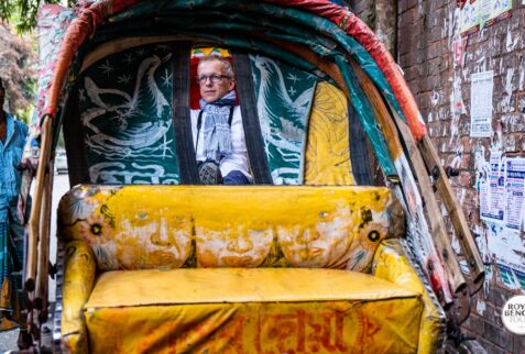 A foreigner is relaxed on the rickshaw in Dhaka