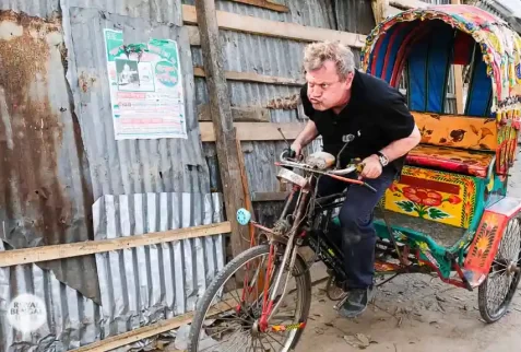 Foreign tourist paddling a rickshaw in Bangladesh