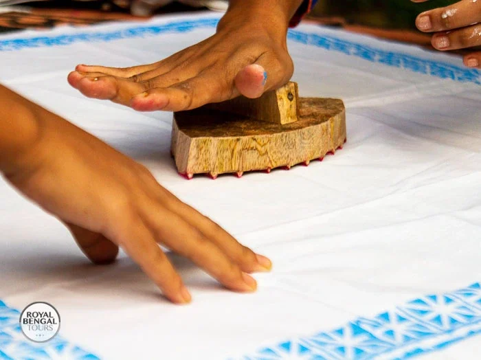 ourists participate in a block printing workshop with local Bangladeshi artisans during a homestay