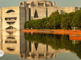 View of the Parliament Building through the crescent lake