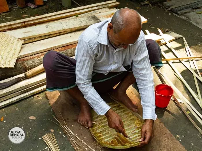 Tourist participates in a traditional Bangladeshi craft workshop during a village homestay