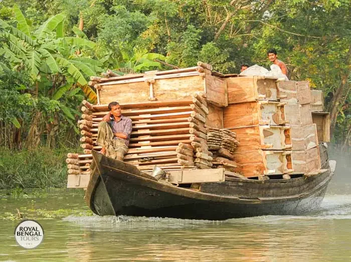 boat loaded with handcrafted wooden furniture on a river in Barisal, Bangladesh