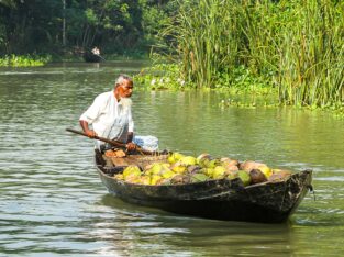 A farmer is on the way to a floating market in Barishal