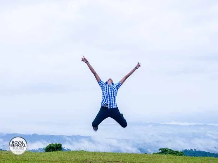 Tourist jumping for joy in the scenic Chittagong Hill Tracts, Bangladesh