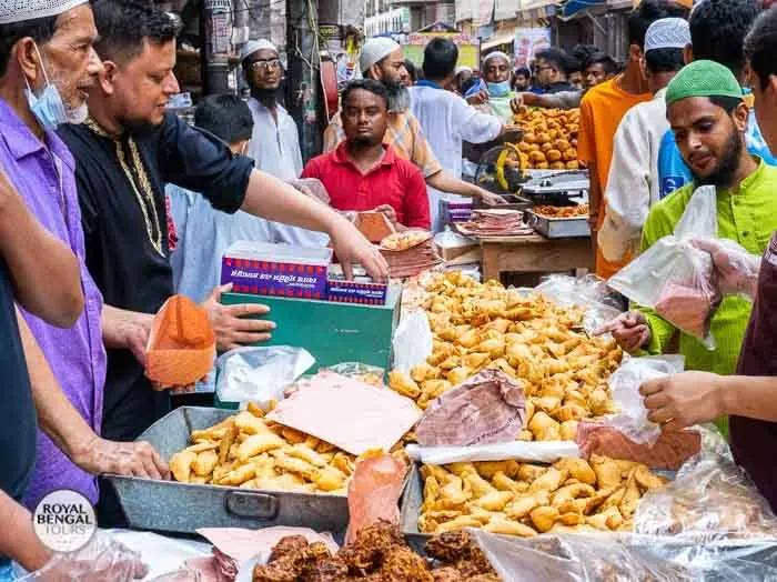 Street food stalls in Old Dhaka, Vendors selling various colorful and flavorful dishes.