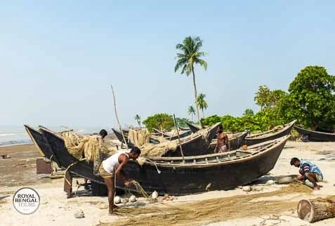 Fishermen are fixing their fishing boats on Kuakata sea beach