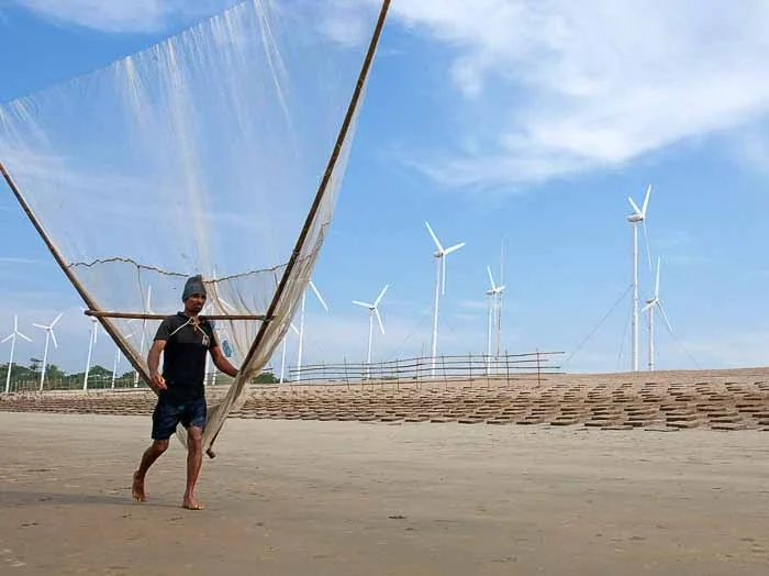 Kutubdia sea beach with wind electric mill by a fishing village