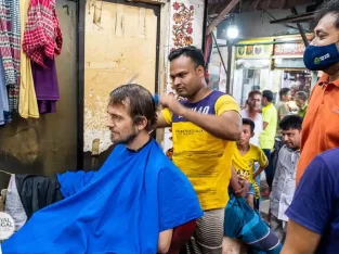 a foreigner takes hair cut in old dhaka saloon
