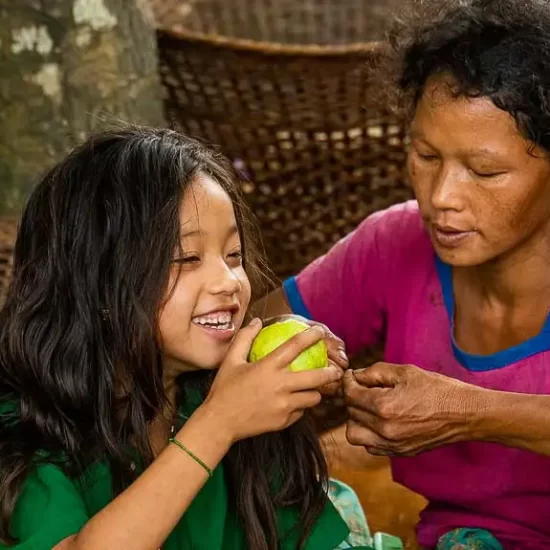 A Tripura girl is incredibly happy with a fruit gift from her mother