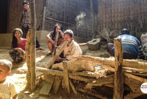 Chakma tribal family smoking bamboo pipe with their own tobacco in Rangamati Hill Tracts