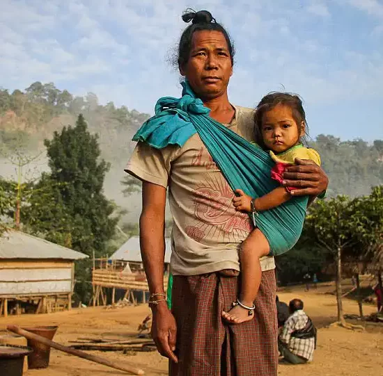 Pangkhua Man with his child on his cloth bag in Chittagong hill tracts