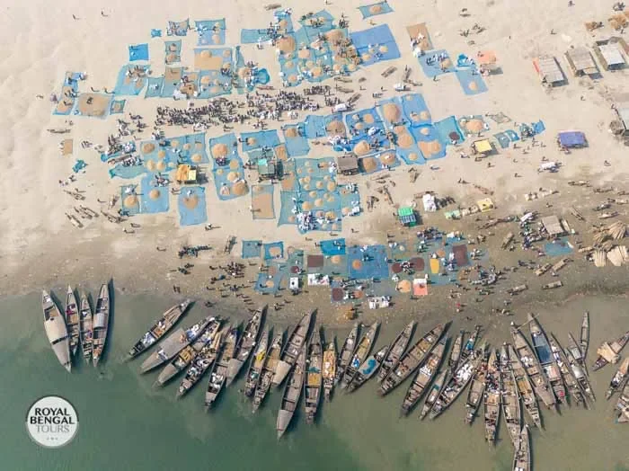 A Char island village market with people buying and selling goods.