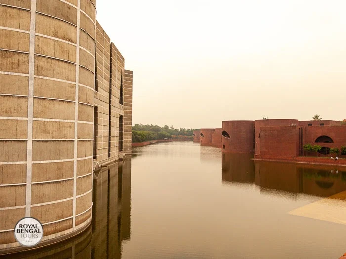 Bangladesh National Parliament, featuring a large water body and the building's distinctive triangular design