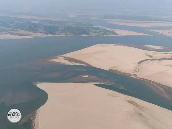 Aerial view of a vast Char island in Bangladesh, showcasing river network and fertile land