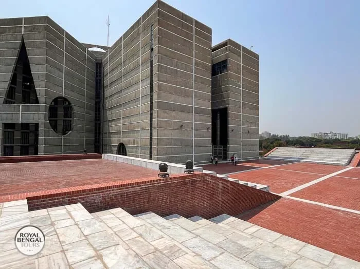 Bangladesh Parliament building's concrete exterior red brick plaza, and steps