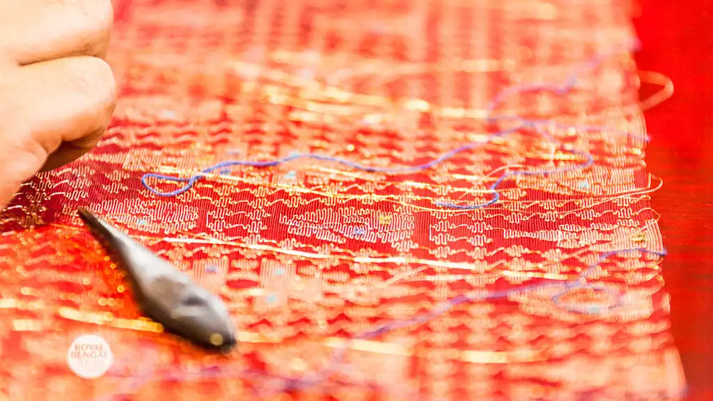 Jamdani artisan weaving a saree on a hand loom in Bangladesh